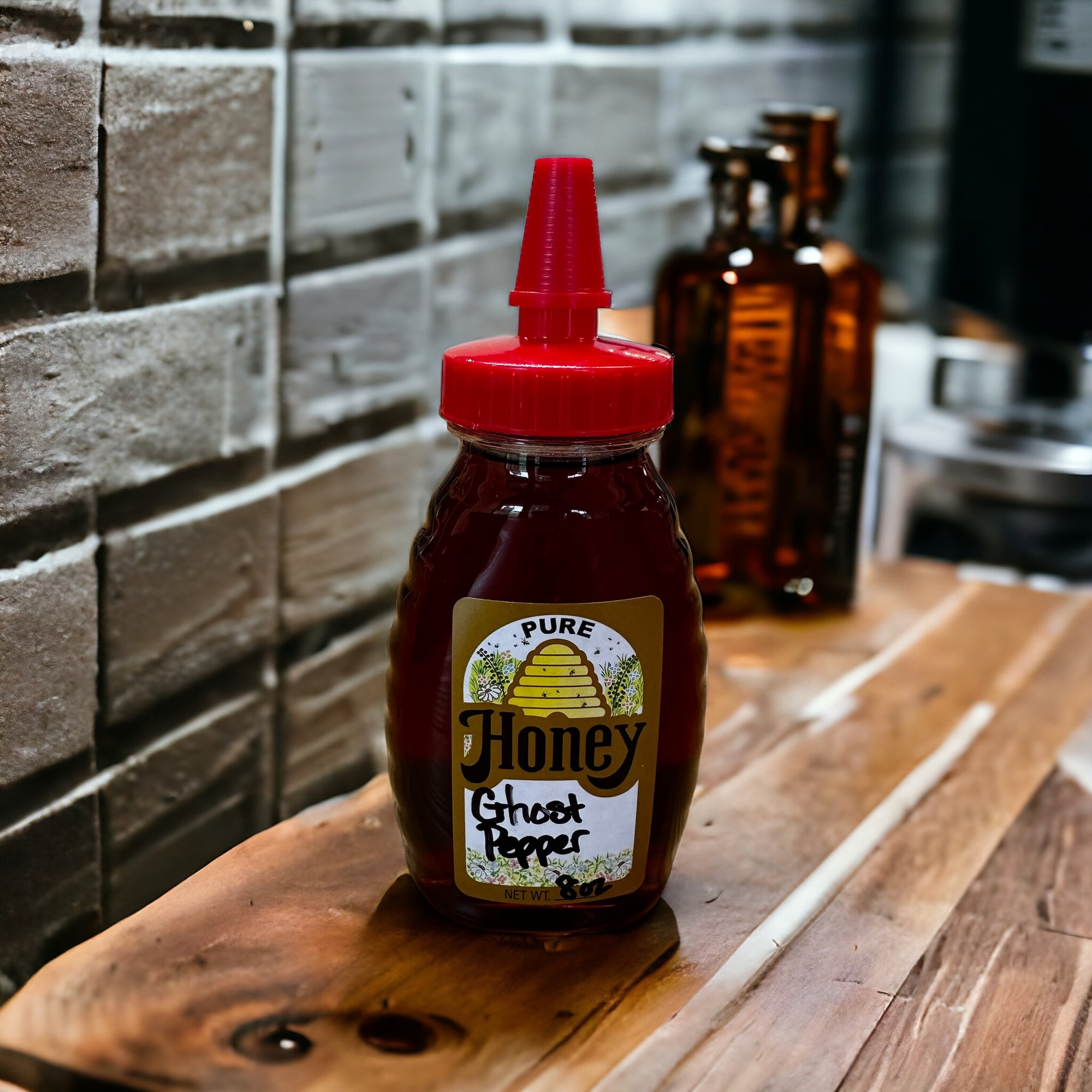 Bottle of ghost pepper honey on a wooden table