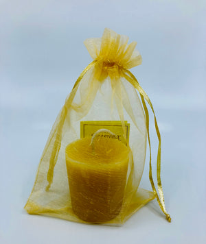 This votive candle is packaged in an organza bag with a small booklet on the benefits of beeswax candles.