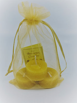 Each tea light set is packaged in a yellow organza bag and also contains a small booklet on the benefits of beeswax candles.